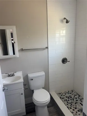 a bathroom with a toilet and a shower