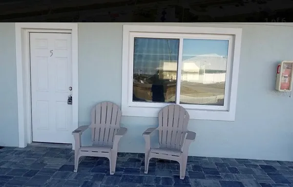a living room with a chair and a window