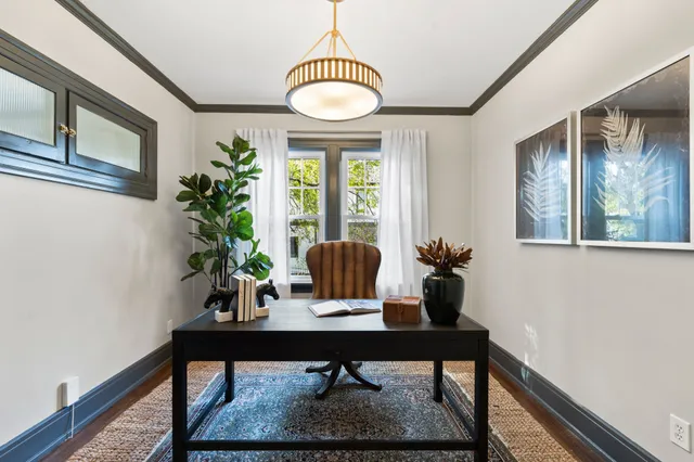 a spacious bedroom with a bed and wooden floor