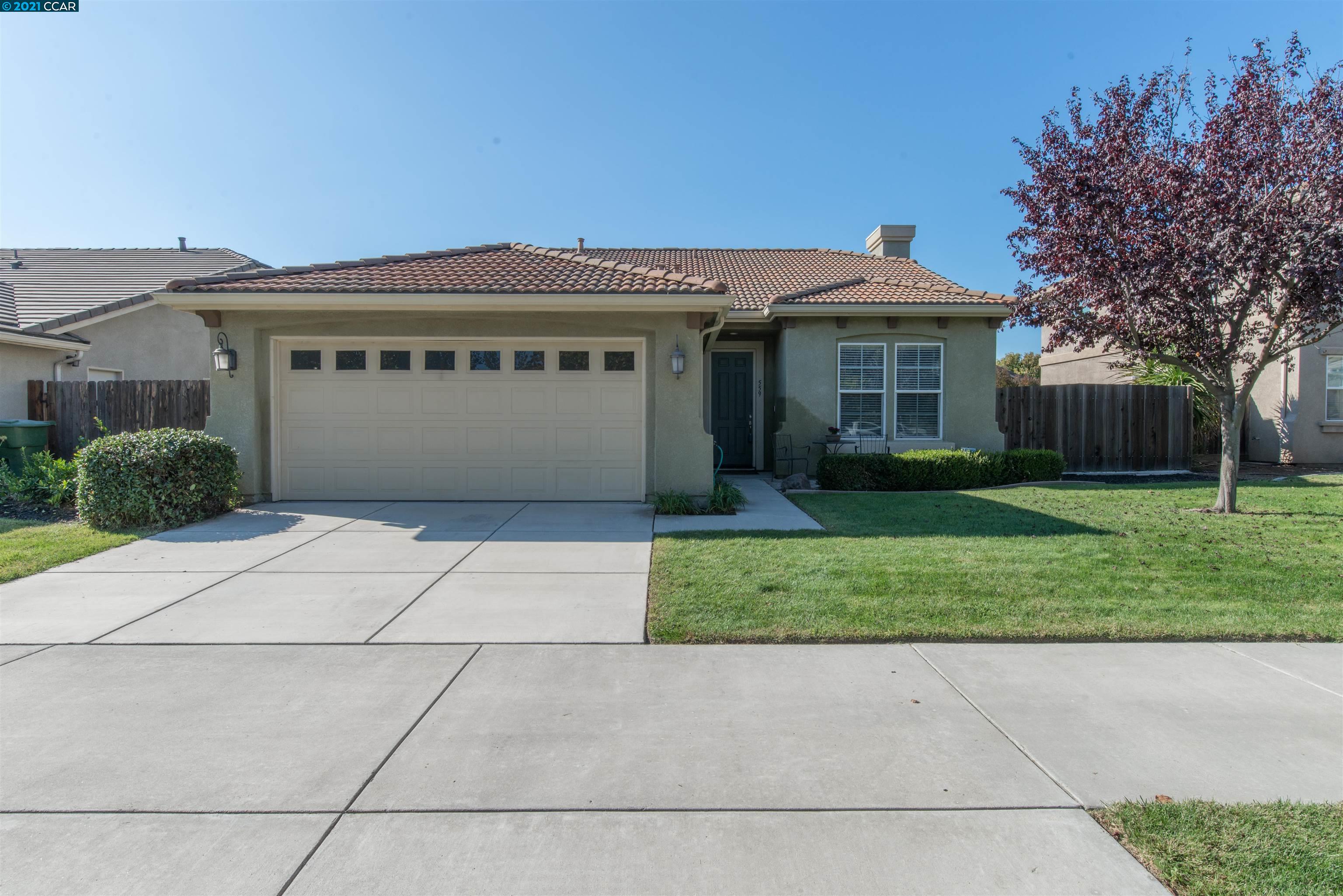 559 Sandy Lane Ripon, CA 95366 - Photo 1 of 1 a front view of a house with a garden and plants