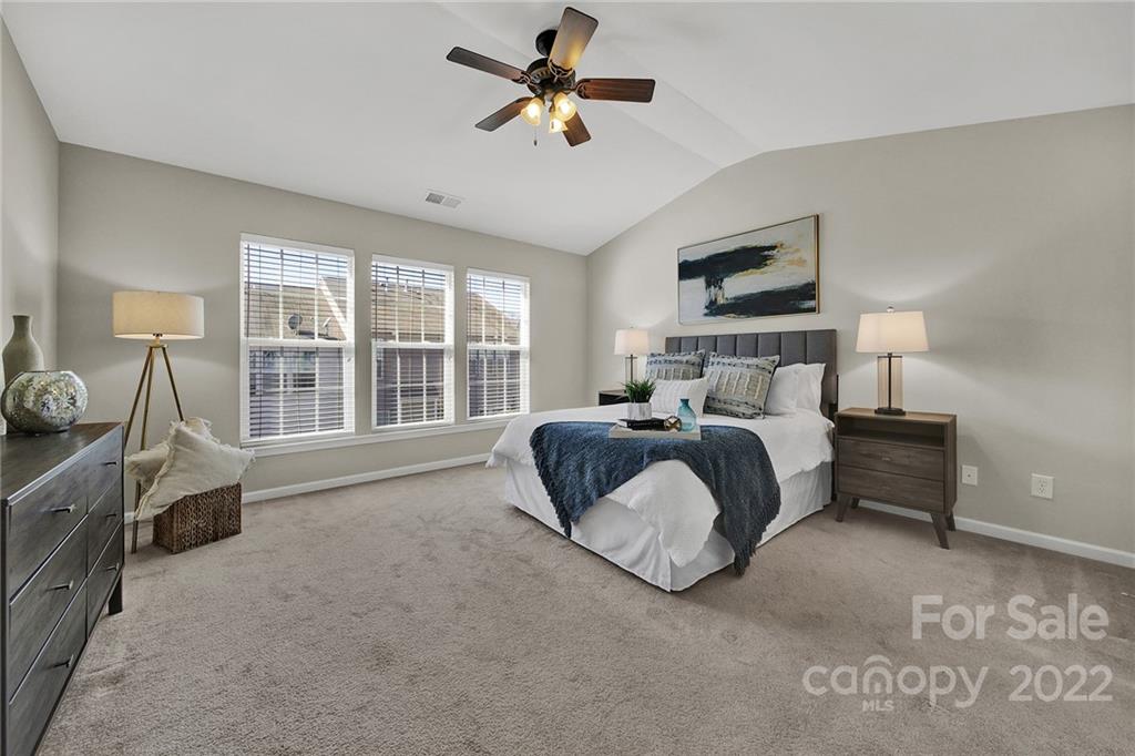 9168 Redmond Trace Road Charlotte, NC 28277 - Photo 13 of 24 a bedroom with a bed chandelier and a window