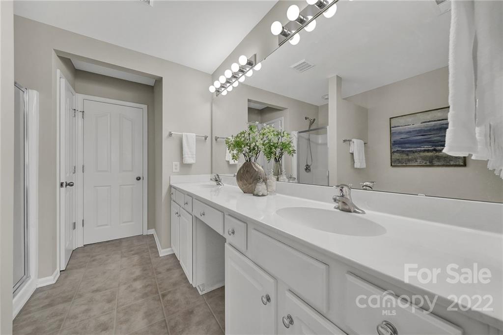9168 Redmond Trace Road Charlotte, NC 28277 - Photo 16 of 24 a spacious en suite bathroom with a double vanity sink and a mirror