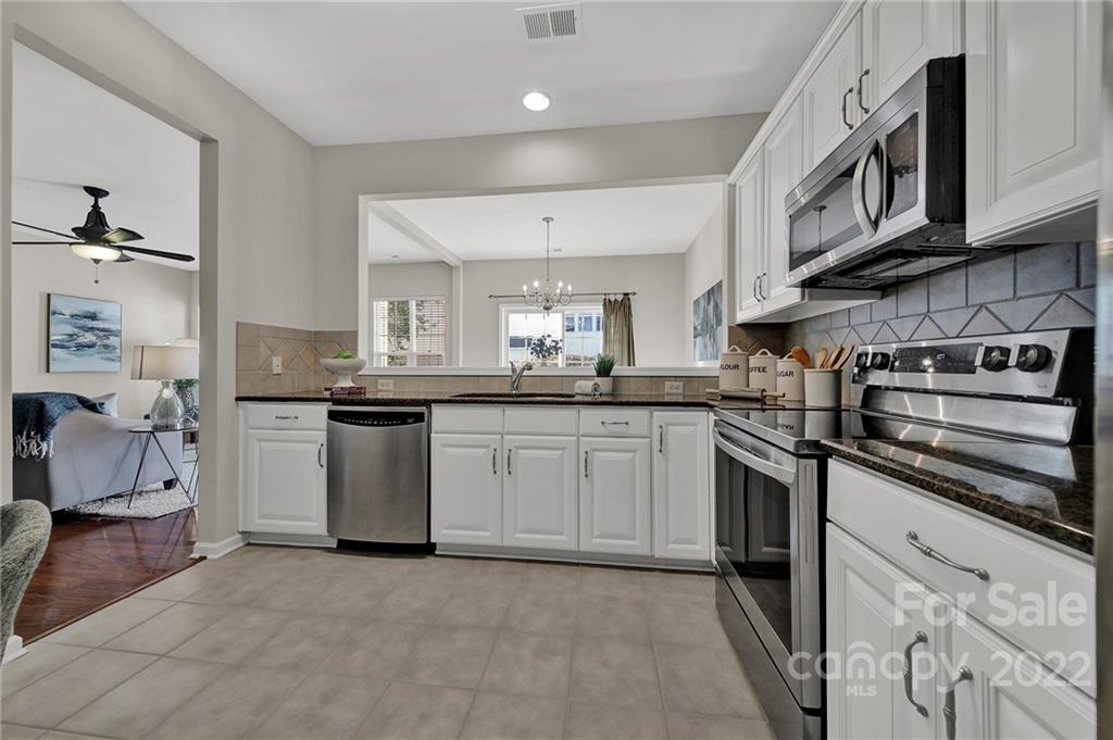 9168 Redmond Trace Road Charlotte, NC 28277 - Photo 8 of 24 a kitchen with stainless steel appliances granite countertop a sink and cabinets
