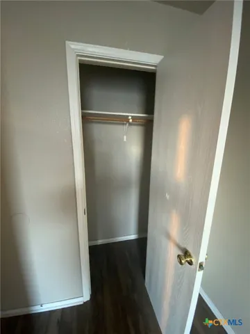 an empty room with wooden floor