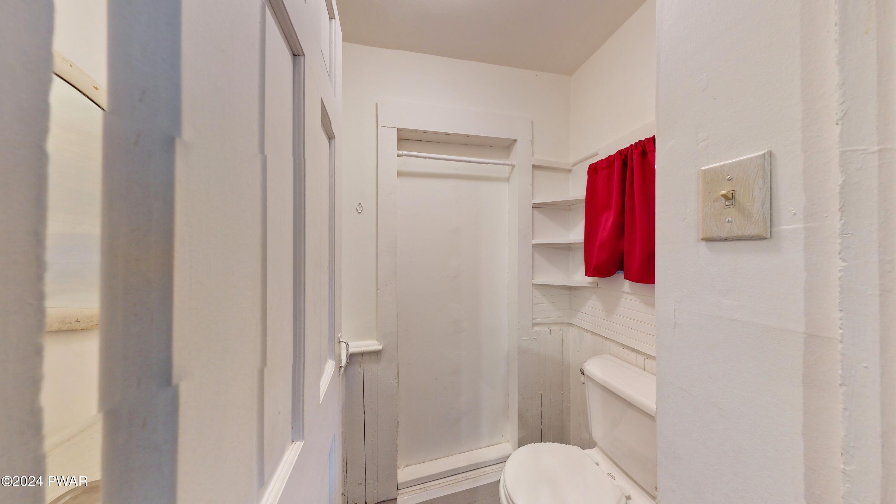 108 9th Street Milford, PA 18337 - Photo 14 of 38 a bathroom with a toilet and a shower curtain