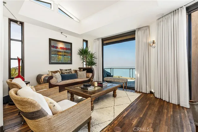 a living room with furniture a lamp and a large window