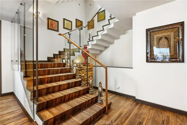 a kitchen with a sink and wooden floor