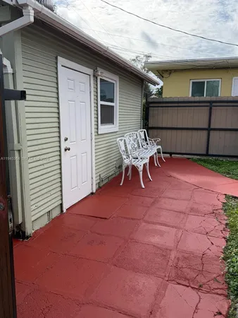 a backyard of a house with outdoor seating