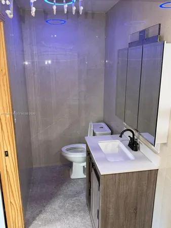 a bathroom with a sink a toilet and shower curtain