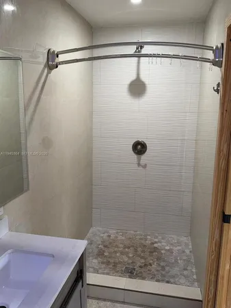 a bathroom with a shower and a bath tub