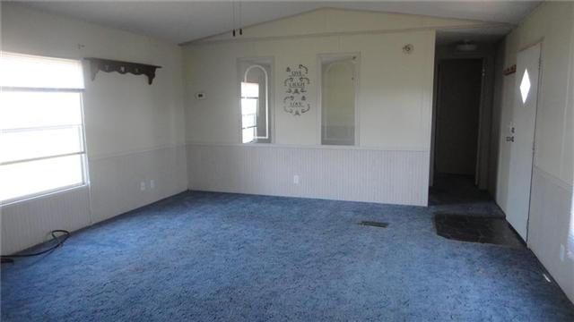 7122 Buncombe Road Belvidere, TN 37306 - Photo 3 of 15 Front door opens directly into the centrally located living room, which features carpet and chair railing.