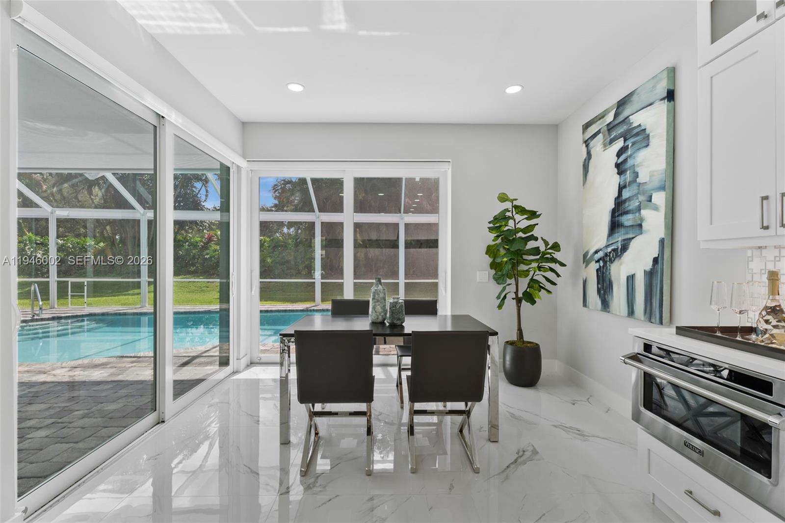 17 Surrey Road Palm Beach Gardens, FL 33418 - Photo 13 of 43 a view of a dining room with furniture window and outside view