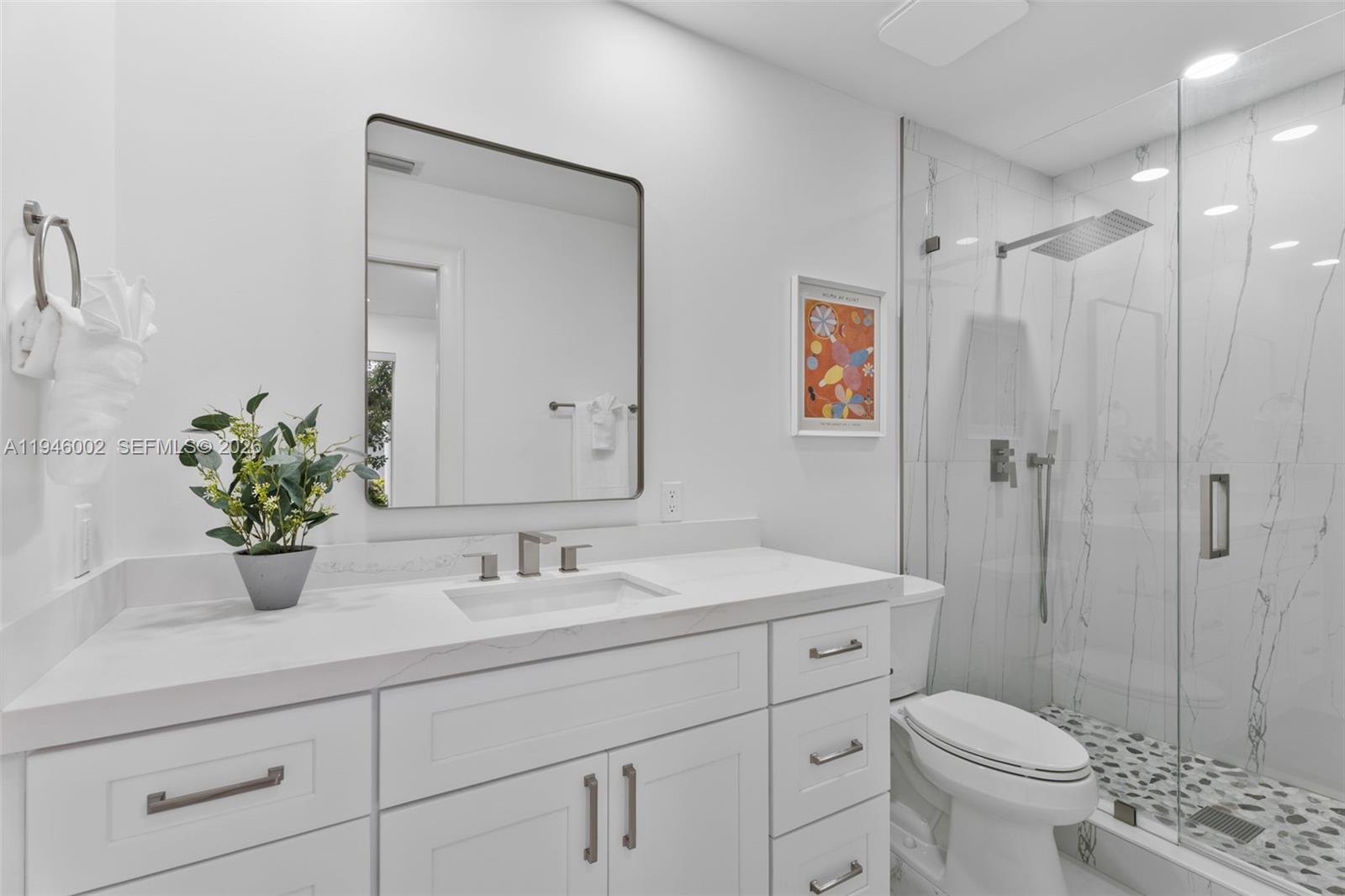 17 Surrey Road Palm Beach Gardens, FL 33418 - Photo 14 of 43 a bathroom with a sink a toilet and shower