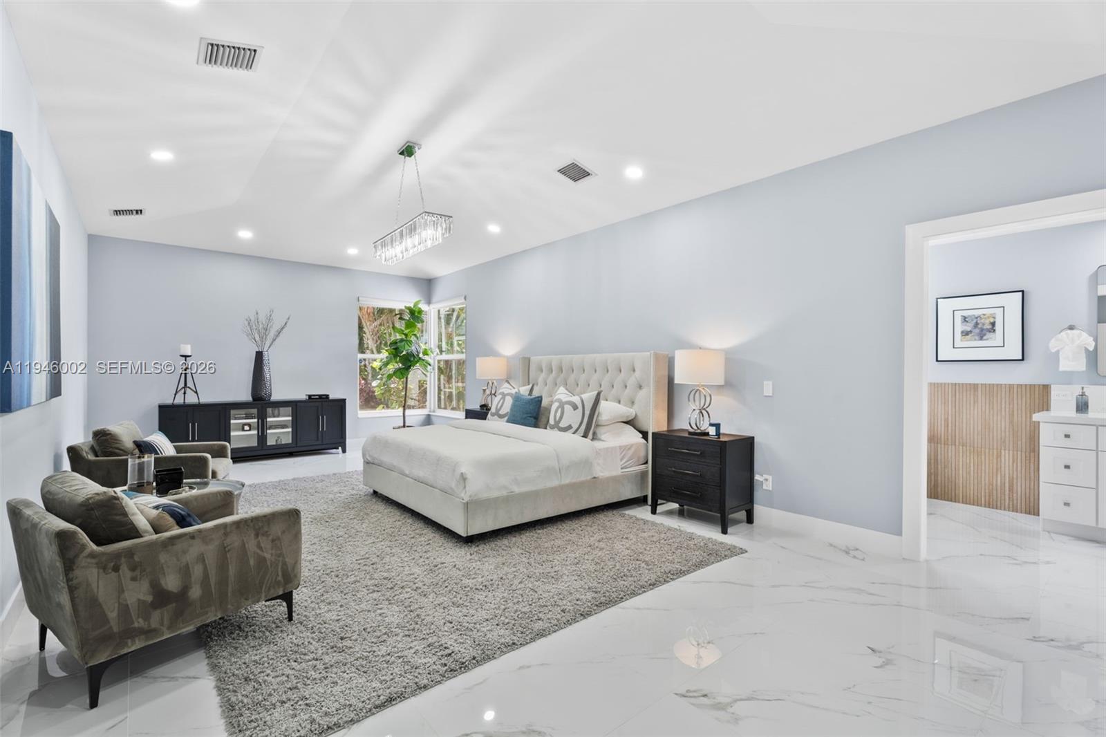 17 Surrey Road Palm Beach Gardens, FL 33418 - Photo 21 of 43 a living room with furniture and a chandelier