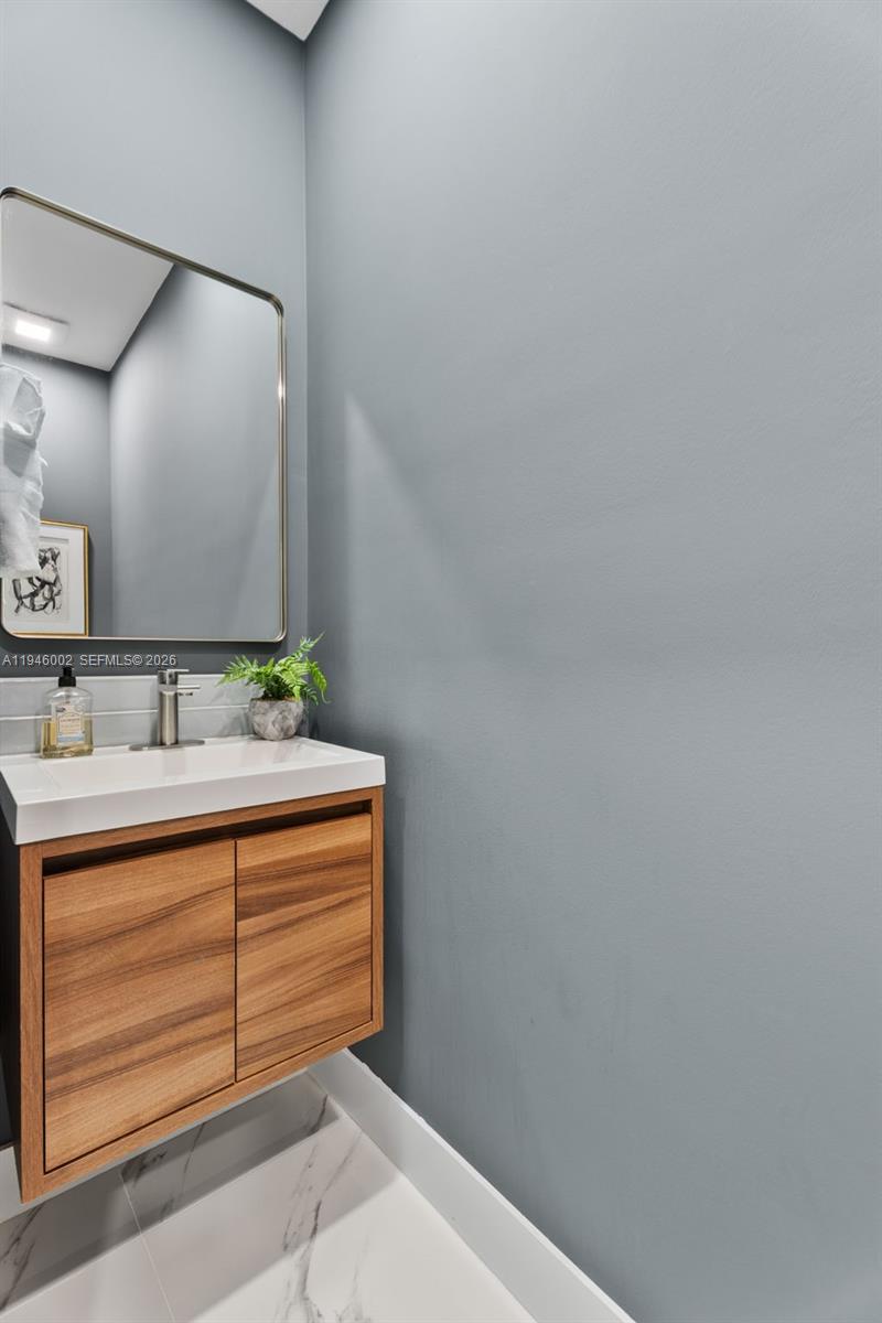 17 Surrey Road Palm Beach Gardens, FL 33418 - Photo 22 of 43 a bathroom with a sink and vanity