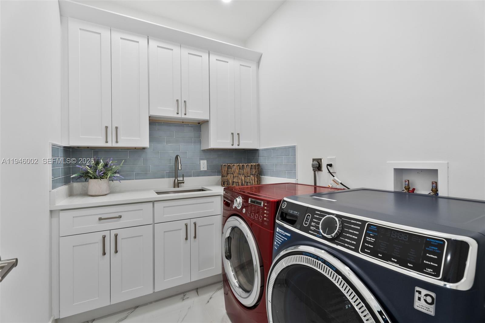 17 Surrey Road Palm Beach Gardens, FL 33418 - Photo 23 of 43 a utility room with dryer and washer