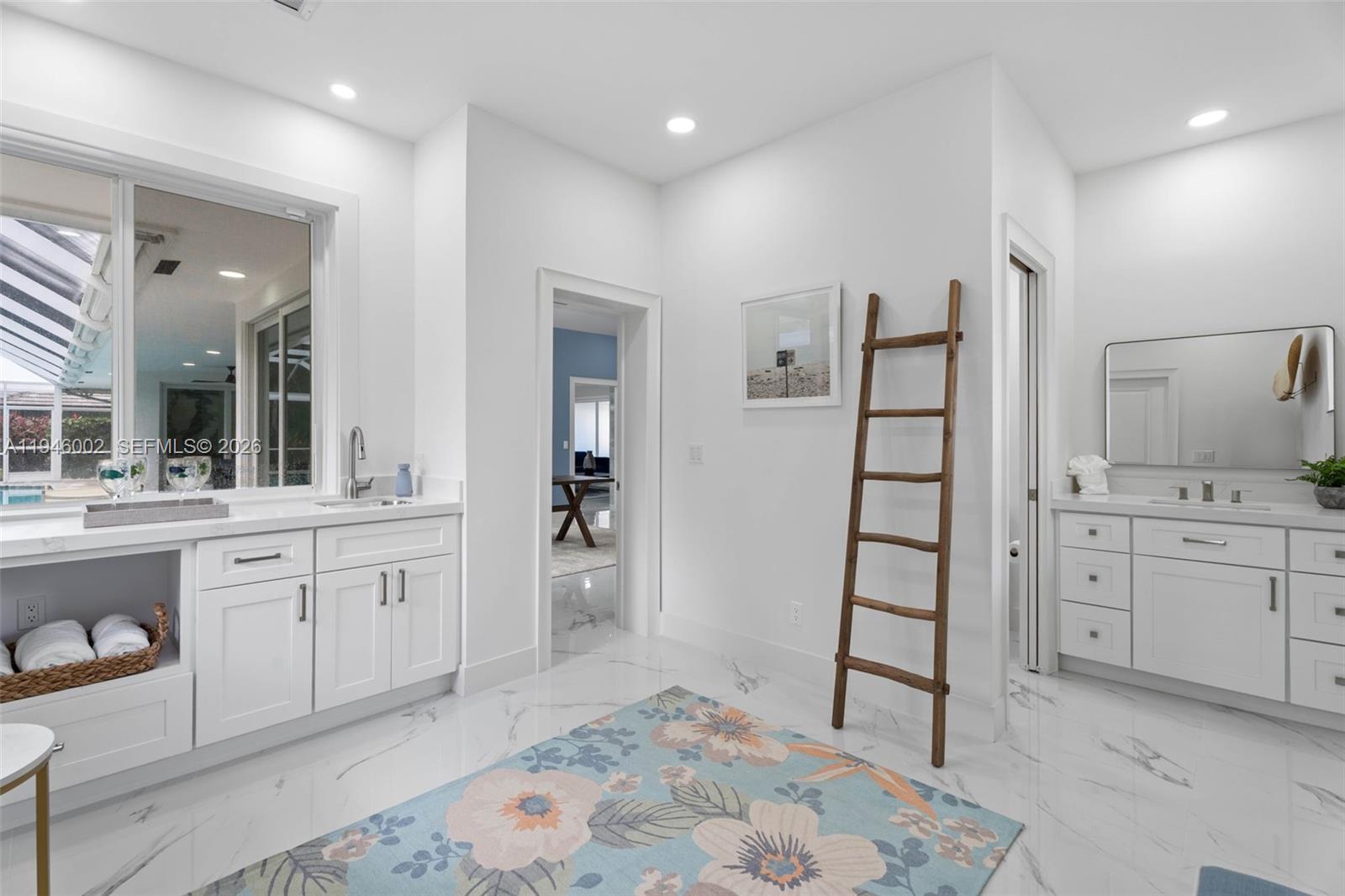 17 Surrey Road Palm Beach Gardens, FL 33418 - Photo 27 of 43 a spacious bathroom with a shower sink and mirror