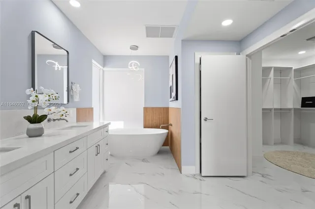 a bathroom with a double vanity sink and a mirror