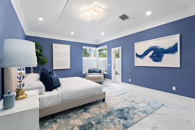 a bedroom with a large bed and a large mirror