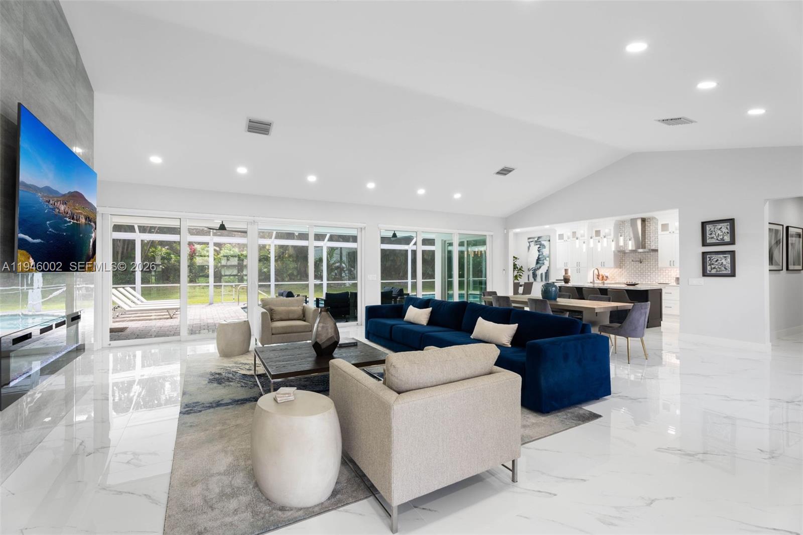 17 Surrey Road Palm Beach Gardens, FL 33418 - Photo 7 of 43 a living room with furniture and a flat screen tv