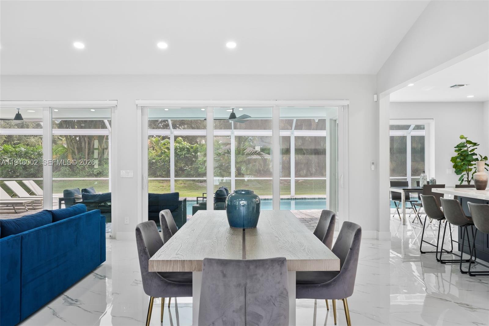 17 Surrey Road Palm Beach Gardens, FL 33418 - Photo 8 of 43 a view of a dining room with furniture large windows and wooden floor