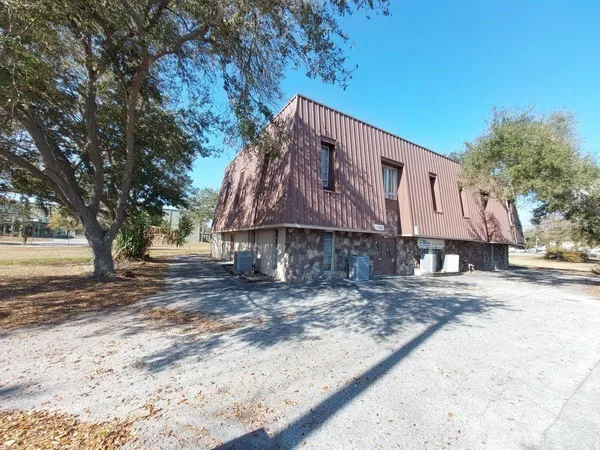 a house that has a tree in front of it