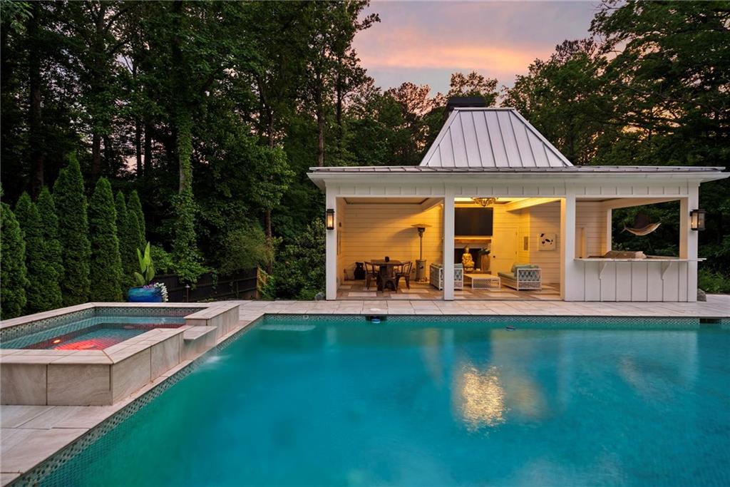 13460 New Providence Road Milton, GA 30004 - Photo 44 of 60 a view of swimming pool with lawn chairs and large trees
