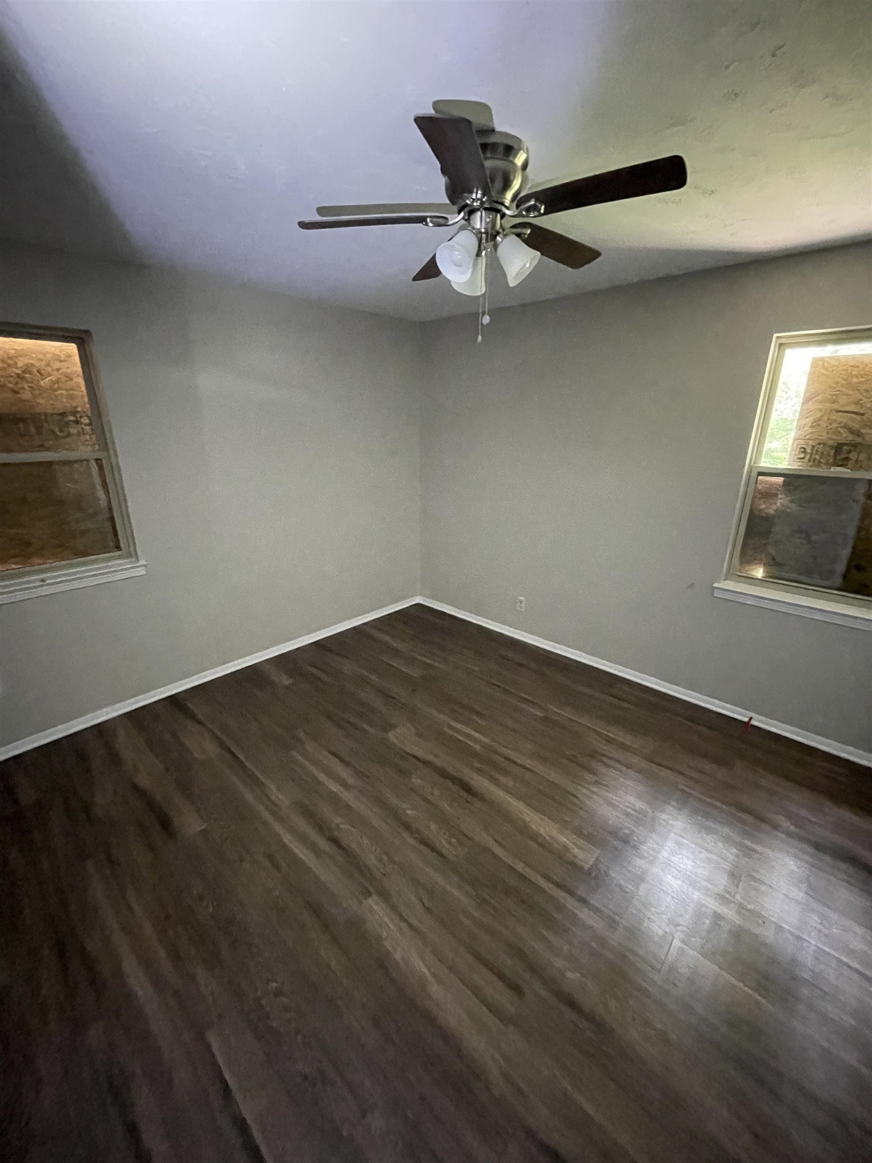 5433 Loch Lomond Road Memphis, TN 38116 - Photo 4 of 4 an empty room with wooden floor fan and windows