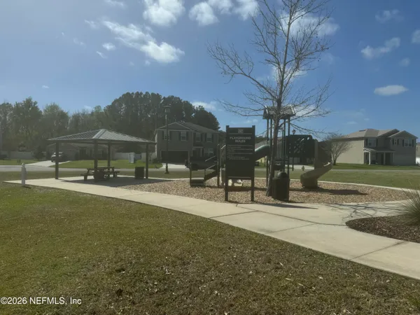 a view of a street with a building in the background