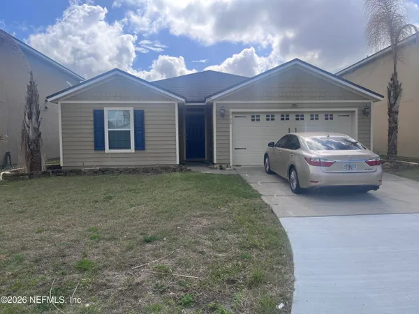 a front view of a house with a garden