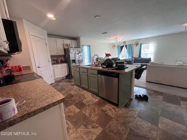 a kitchen with stainless steel appliances granite countertop a stove oven and a refrigerator