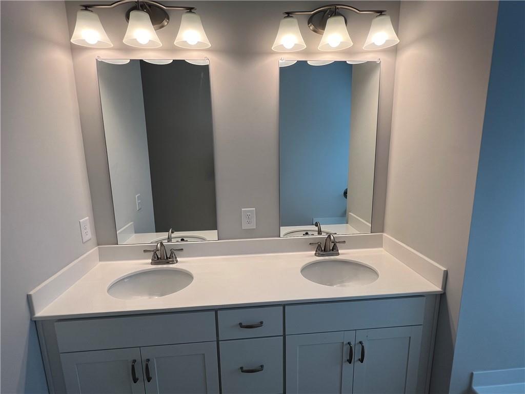 243 Witter Way Woodstock, GA 30188 - Photo 15 of 45 a bathroom with a sink and a mirror