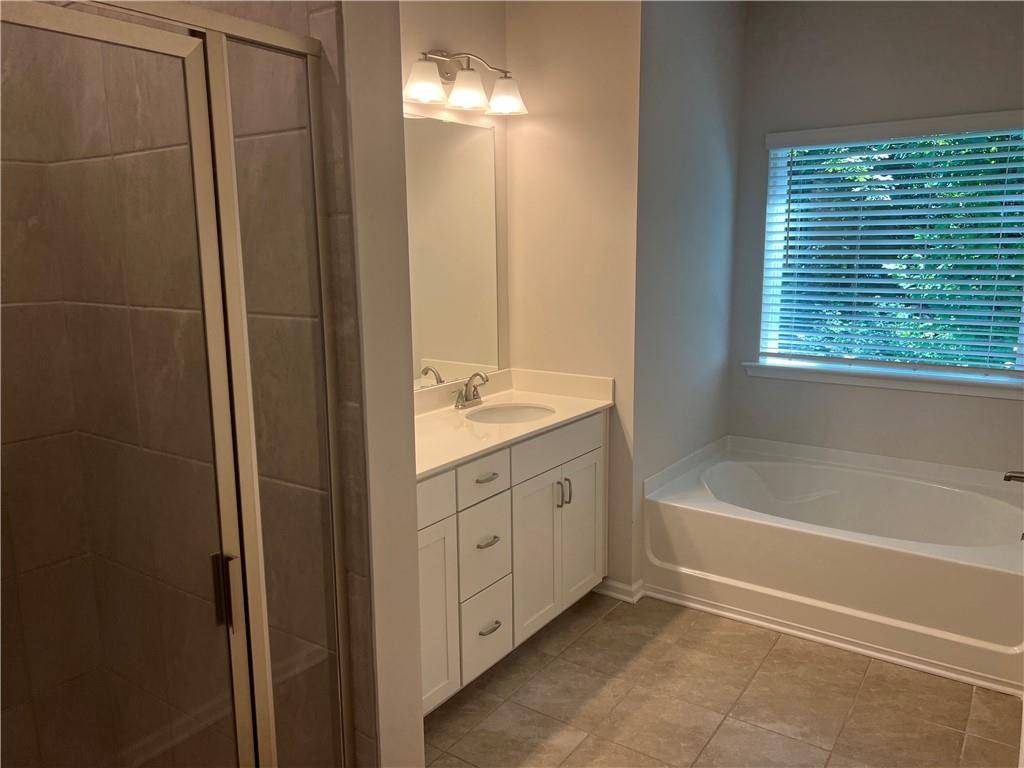 243 Witter Way Woodstock, GA 30188 - Photo 20 of 45 a bathroom with a tub sink and mirror