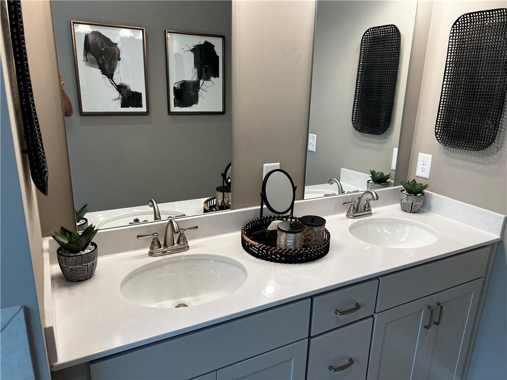 243 Witter Way Woodstock, GA 30188 - Photo 28 of 45 a bathroom with a sink and a mirror