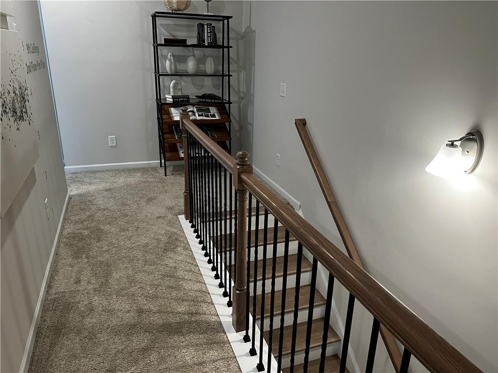 243 Witter Way Woodstock, GA 30188 - Photo 30 of 45 a view of a hallway with wooden floor and stairs