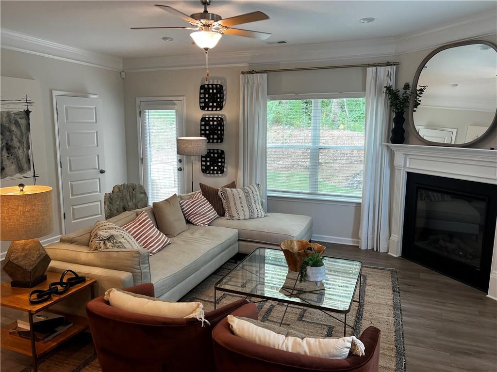 243 Witter Way Woodstock, GA 30188 - Photo 32 of 45 a living room with furniture a fireplace and a large window