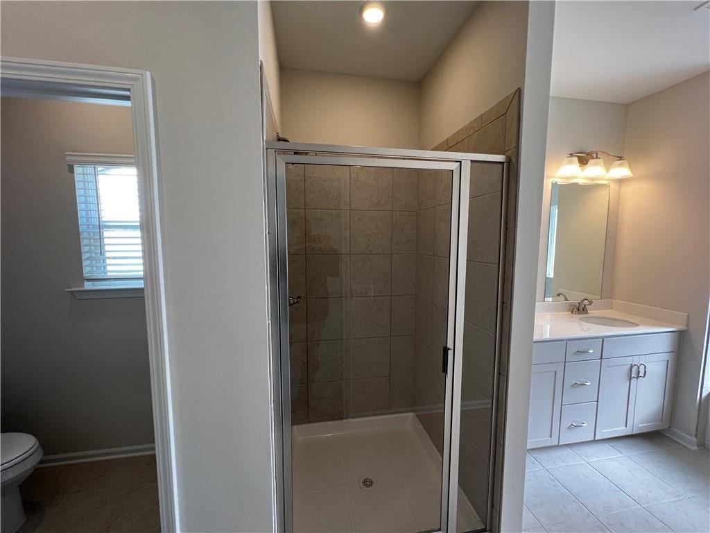 243 Witter Way Woodstock, GA 30188 - Photo 38 of 45 a bathroom with a shower and a toilet