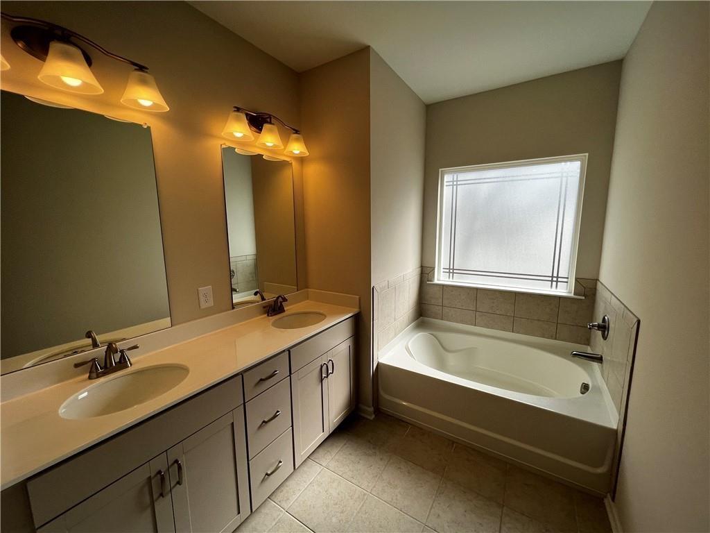 243 Witter Way Woodstock, GA 30188 - Photo 39 of 45 a bathroom with a tub sink and mirror