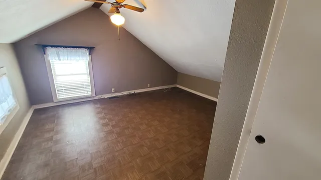 a backyard of a house with plants and barbeque oven