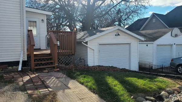 a view of a house with backyard and trees