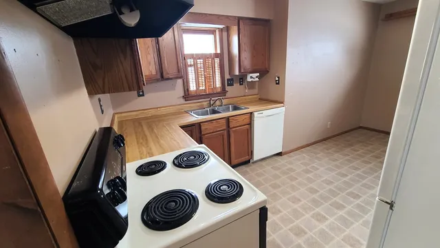 a utility room with sink dryer and washer