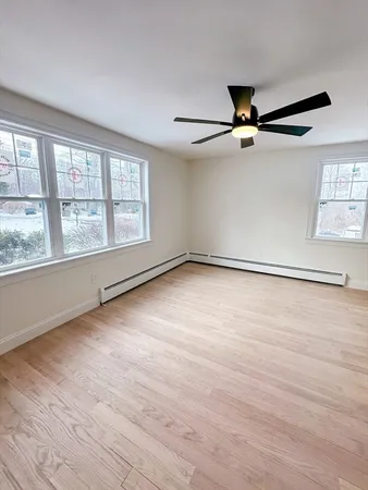 wooden floor in an empty room with a window