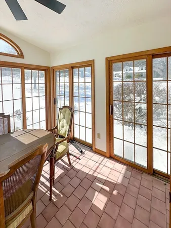 a view of a workspace with furniture and a window