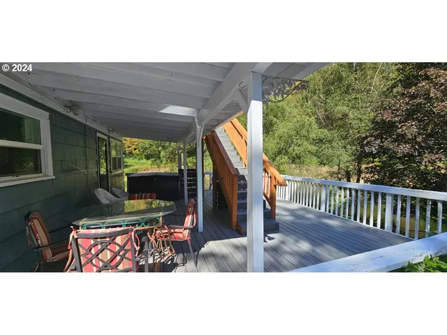 a kitchen with stainless steel appliances granite countertop a refrigerator a stove and a sink with wooden cabinets