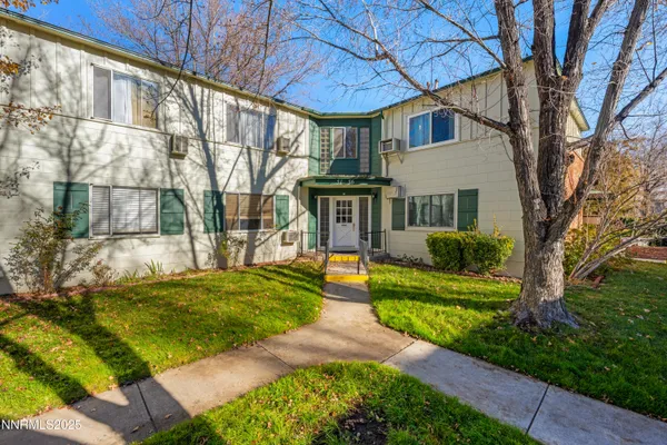 a front view of a house with a yard table and chairs