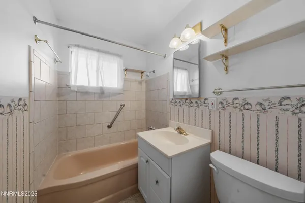 a view of a room with a window and a ceiling fan