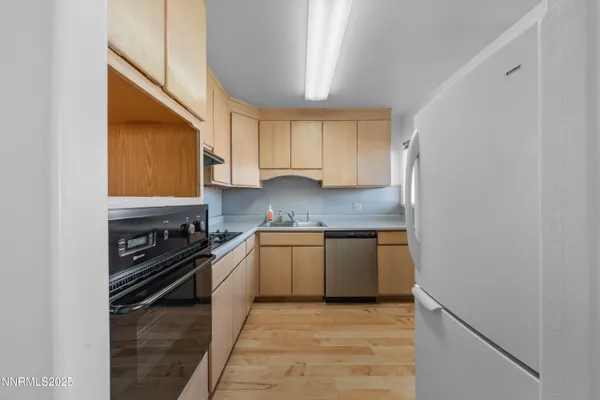 a kitchen with cabinets appliances and a window