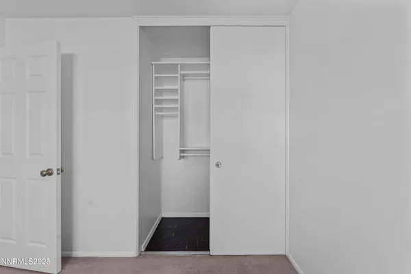 a view of a hallway with bathroom