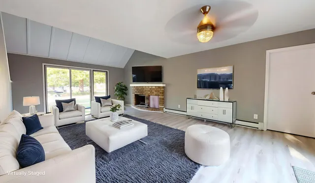 a living room with furniture fireplace and a flat screen tv