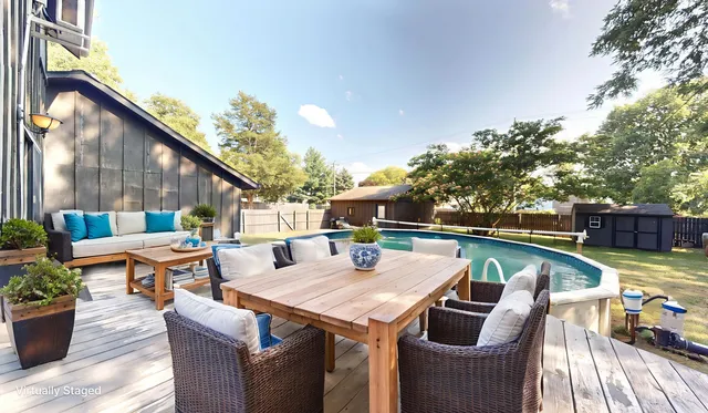 a terrace with outdoor seating and wooden floor